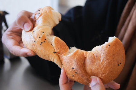 Delectable Handheld Bread Topped Generously with Crunchy Sesame Seedsの写真素材