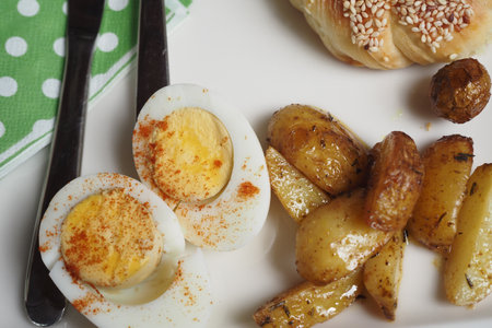 A Breakfast Plate Featuring Eggs and Roasted Potatoesの写真素材