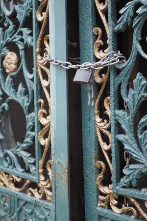Closed old rusty lock on a wooden doorの写真素材