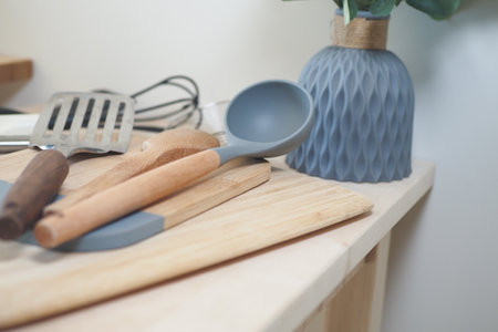 Stylish kitchen utensils and a vase are displayed on the countertopの写真素材