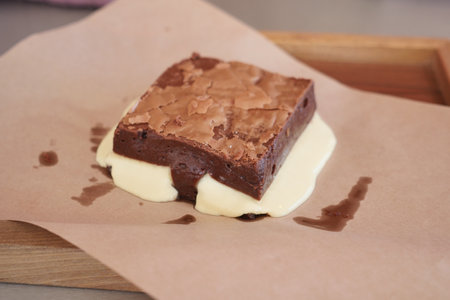 Enjoy a Delicious Brownie served with Melting Ice Cream on Brown Paperの写真素材