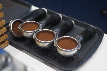 Four Coffee Portafilters Are Prepared and Ready for Brewing a Perfect Cupの写真素材