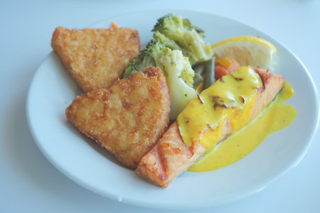 grill salmon served with fresh vegetables on a plateの写真素材