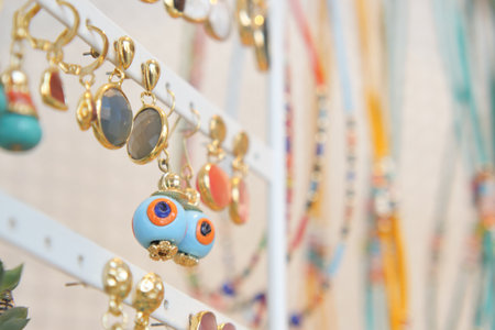 A Colorful Jewelry Display Featuring Unique and Artistic Earrings and Necklacesの写真素材