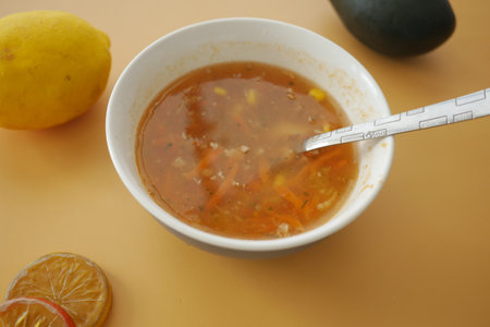 Enjoy a Delicious and Flavorful Bowl of Fresh Vegetable Soup with Citrus Fruitsの写真素材
