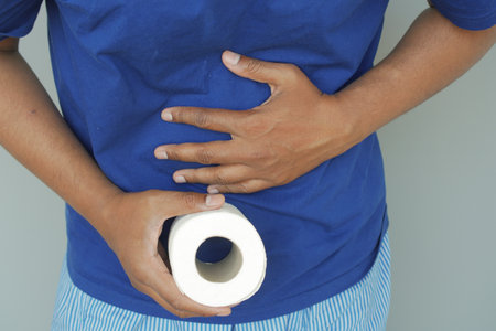 Discomfort and Relief: Holding Toilet Paper for Stomach Issuesの写真素材