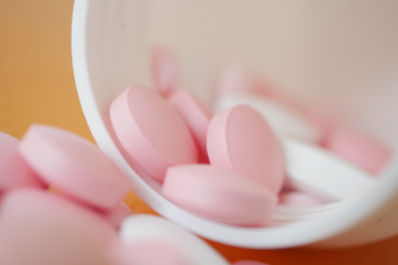 Close-Up of Pink Tablets on a Soft Surfaceの写真素材
