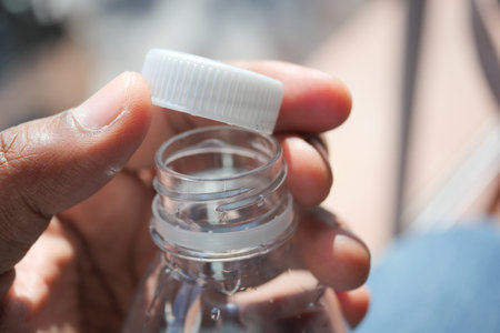 open a cap of a plastic water bottleの写真素材