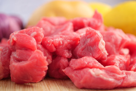 Fresh Cuts of Raw Beef Placed Elegantly on a Wooden Serving Boardの写真素材