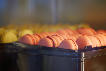 An Array of Colorful Macarons Beautifully Displayed in a Bakery Caseの写真素材