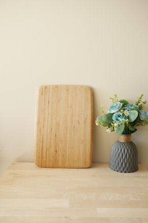 A Wooden Cutting Board beautifully designed with a Decorative Flower Vaseの写真素材