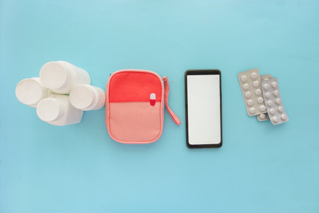 Essential Health Items That You Need Phone, Medication, and Organizersの写真素材