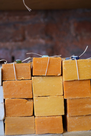 Vibrant and Colorful Handmade Soaps Beautifully Displayed on a Wooden Shelfの写真素材