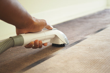 A CloseUp View of Vacuuming a Carpet in a Contemporary Living Room Environment Todayの写真素材
