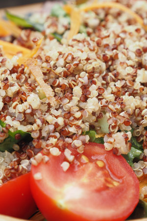 Healthy Red Quinoa and Fresh Vegetable Salad with Tomato Garnishの写真素材
