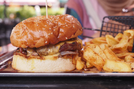 Cheeseburger With chips on a wooden tableの写真素材
