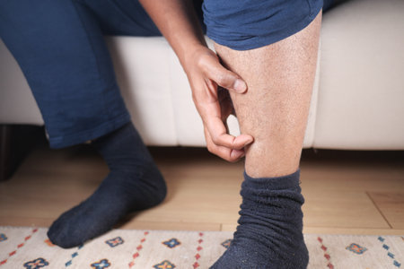 man suffering from itching skin on his feetの写真素材