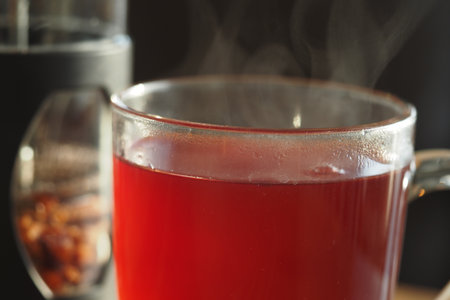 A Glass Cup Filled with Freshly Brewed Hot Tea, Steam Gently Risingの写真素材