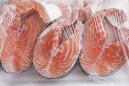 Vacuum Packaging Fresh Salmon Fillets Served with a Delightful Array of Vegetablesの写真素材