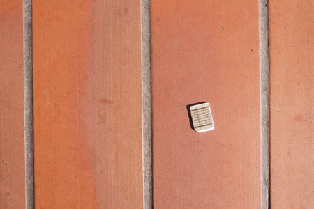 a phone sim card dropped on a tiles floor.の写真素材