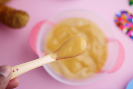 Colorful Baby Meal with Wooden Toys on Pink Backgroundの写真素材