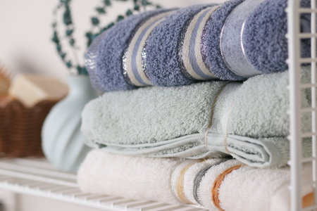 Beautifully Stacked Towels on a Shelving Unit Elegant Home Decorの写真素材
