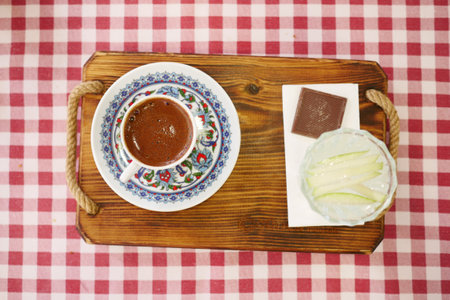 Turkish Coffee in Floral Cup on Checkered Tableclothの写真素材