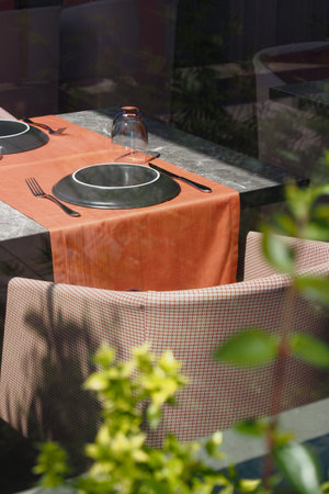 An Elegant Outdoor Dining Setting Surrounded by Beautiful Greeneryの写真素材