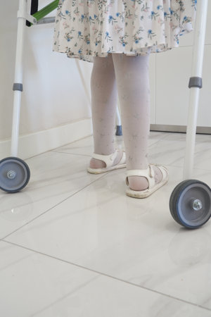 child with walking frame indoorの写真素材