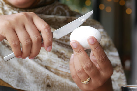 Effectively Cutting a Boiled Egg with a Knife for Your Meals and Snacksの写真素材