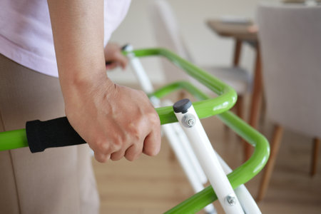 A Person Using a Modern Walker in a Bright and Welcoming Living Space for Increased Mobilityの写真素材