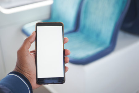 young man hand using smart phone with green screen inside of metro trainの写真素材