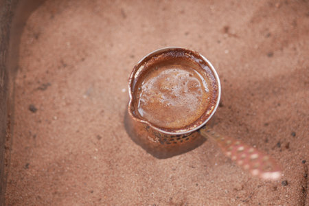 top view of making traditional turkish coffee on sandの写真素材