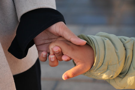 Tender Moment A Child Holding an Adults Hand, a beautiful symbol of love and connectionの写真素材