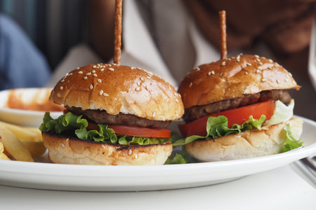 Indulge in Delicious Gourmet Burgers Prepared with Fresh Ingredientsの写真素材