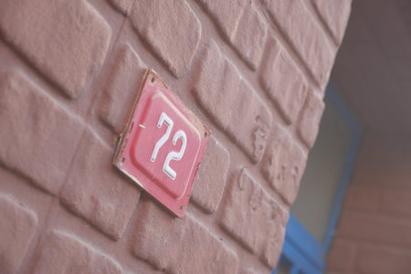 The charming House Number 72 is featured prominently on a textured wall