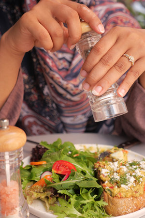 Savoring a Fresh, Flavorful Salad Highlighted with Appetizing Seasoningの写真素材