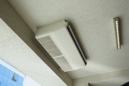 Installation of a modern ceiling air conditioner within the office spaceの写真素材