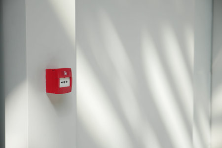 Red fire alarm button on wall ,