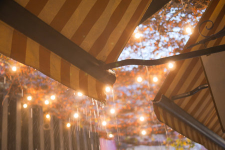 A Rainy Night in the City Filled with Lanterns and a Beautiful Orange Canopy Aboveの写真素材