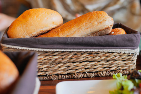 Deliciously Freshly Baked Bread Rolls Presented in Rustic Basketの写真素材