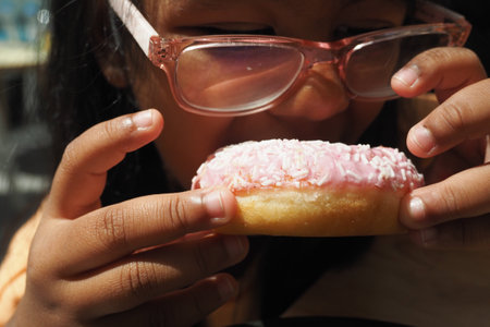 child mouth eating donutsの写真素材