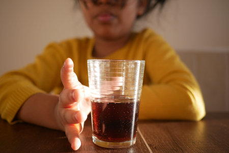 Enjoying a Casual Moment with a Refreshing Glass of Dark Beverage Today