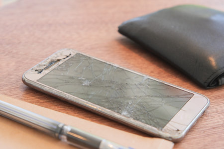 Top view of broken smart phone on color background