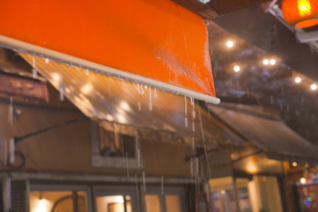 A Rainy Night in the City Filled with Lanterns and a Beautiful Orange Canopy Above