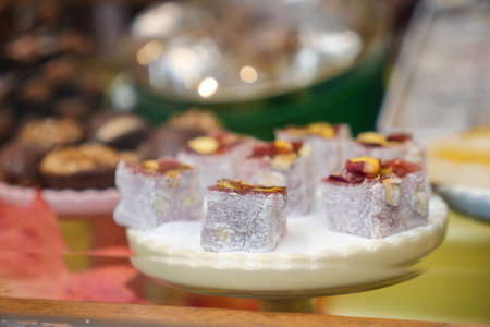 Assorted Colorful Turkish Delight Cubes on a White Plateの写真素材