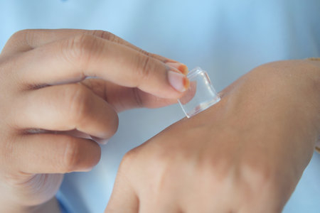 woman rubbing ice cube on her hand.の写真素材