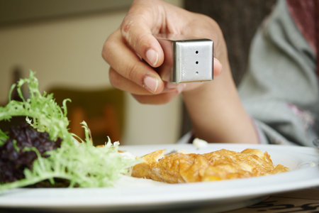 Salt falls from a salt shakerの写真素材