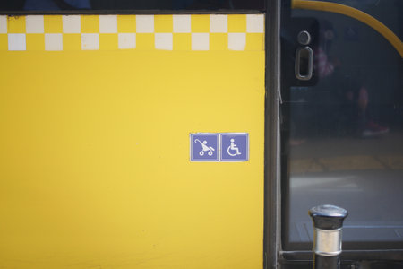 Enhancing accessibility with yellow checkerboard symbols for public transportation icon displayの写真素材