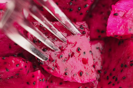 Delicious and Vibrant Dragon Fruit Cubes Served with a Silver Forkの写真素材